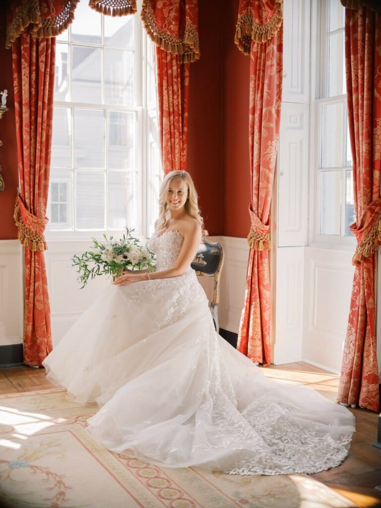 Ellie Wearing Charla gown sitting red room